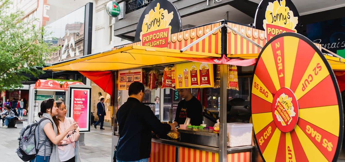 A Jonny's Popcorn stall set up in a mall