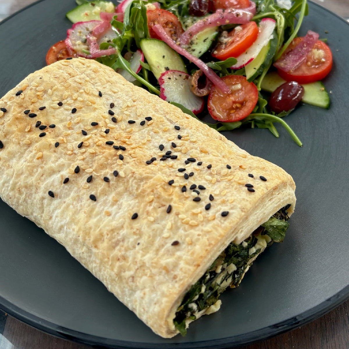 A serve of Continental Bakery Vegan Spinach & Cheese Roll