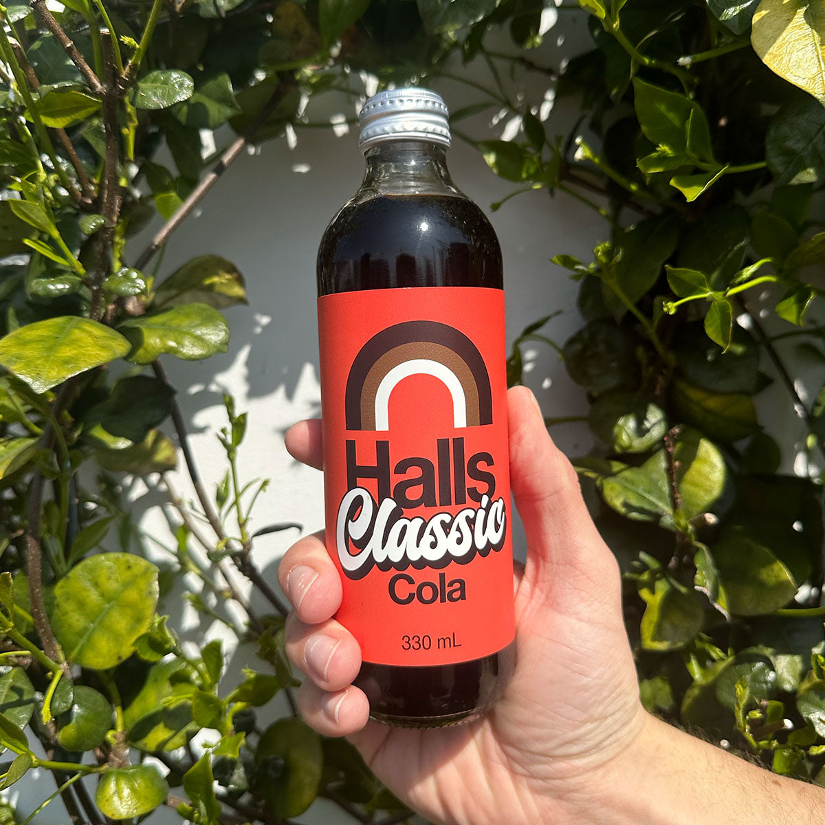 A 330ml glass bottle of Halls Classic Cola