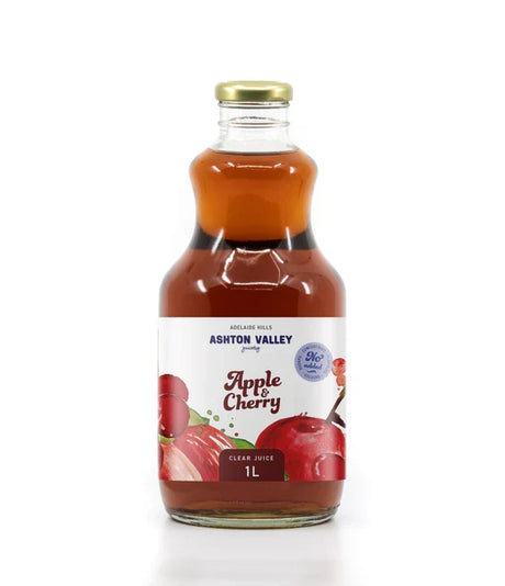A 1L glass of Ashton Valley Juicery still clear apple and cherry juice