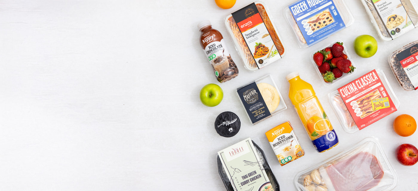 Assorted food products including juice, snacks, and fruits on a white background