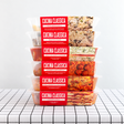 A stack of packaged meals from Cucina Classica on a table