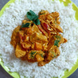 A portion of din-a-dun Jackfruit Curry served on a plate with rice