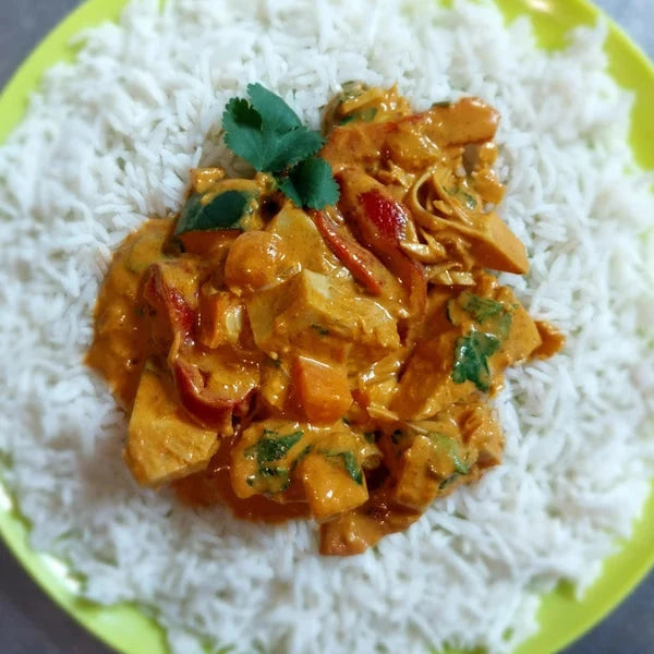 A portion of din-a-dun Jackfruit Curry served on a plate with rice
