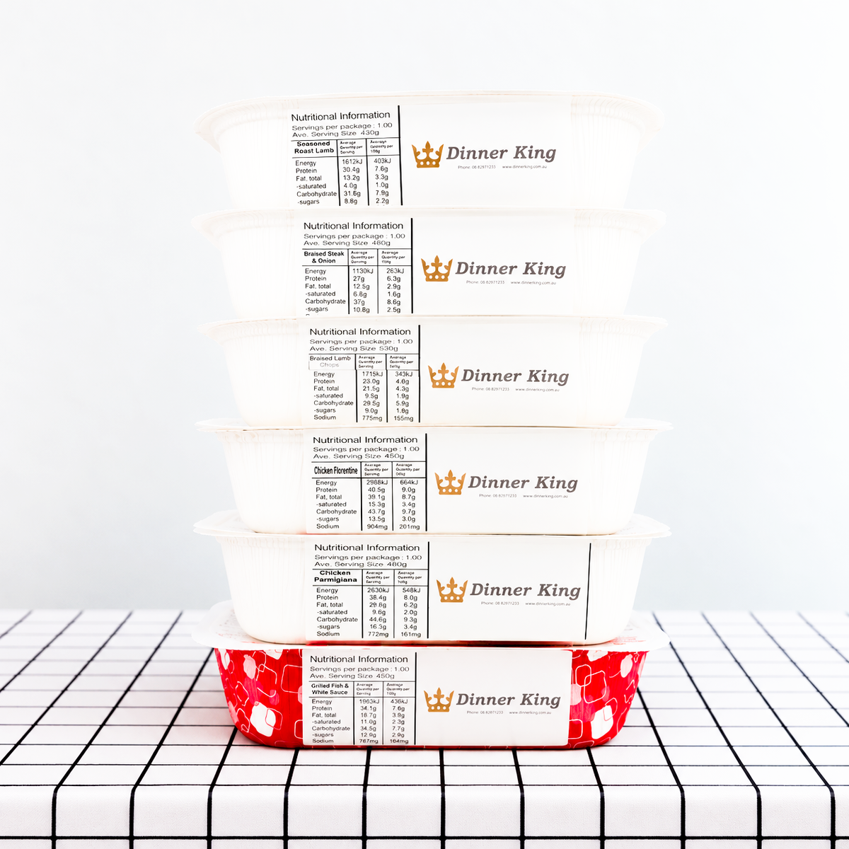 A stack of packaged meals from Dinner King on a table