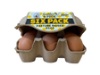 Six-pack of pasture-raised eggs in a cardboard carton with 'feather & peck' branding.