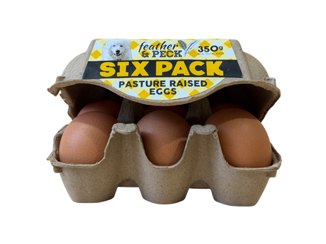 Six-pack of pasture-raised eggs in a cardboard carton with 'feather & peck' branding.