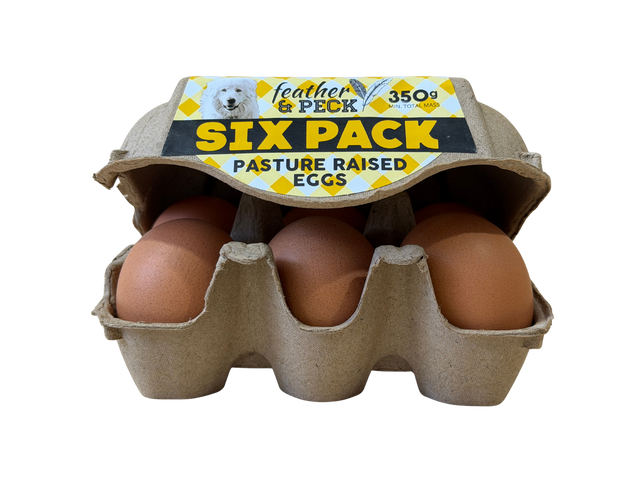 Six-pack of pasture-raised eggs in a cardboard carton with 'feather & peck' branding.