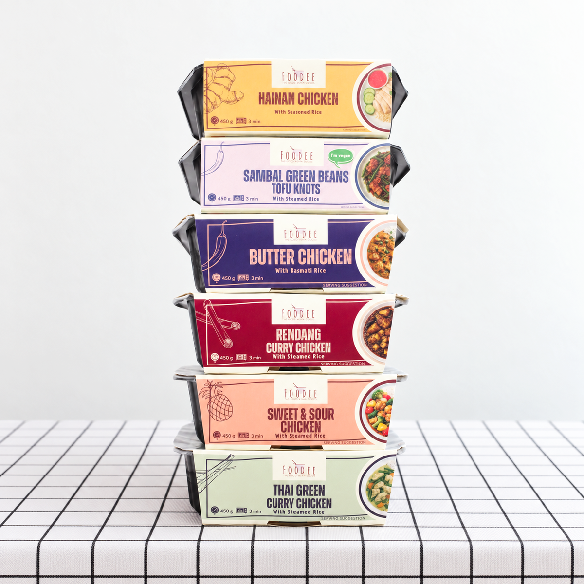A stack of packaged meals from Foodee on a table