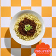 Bowl of ramen with green onions on a checkered orange and white background, featuring the Nourish Little Lives logo.